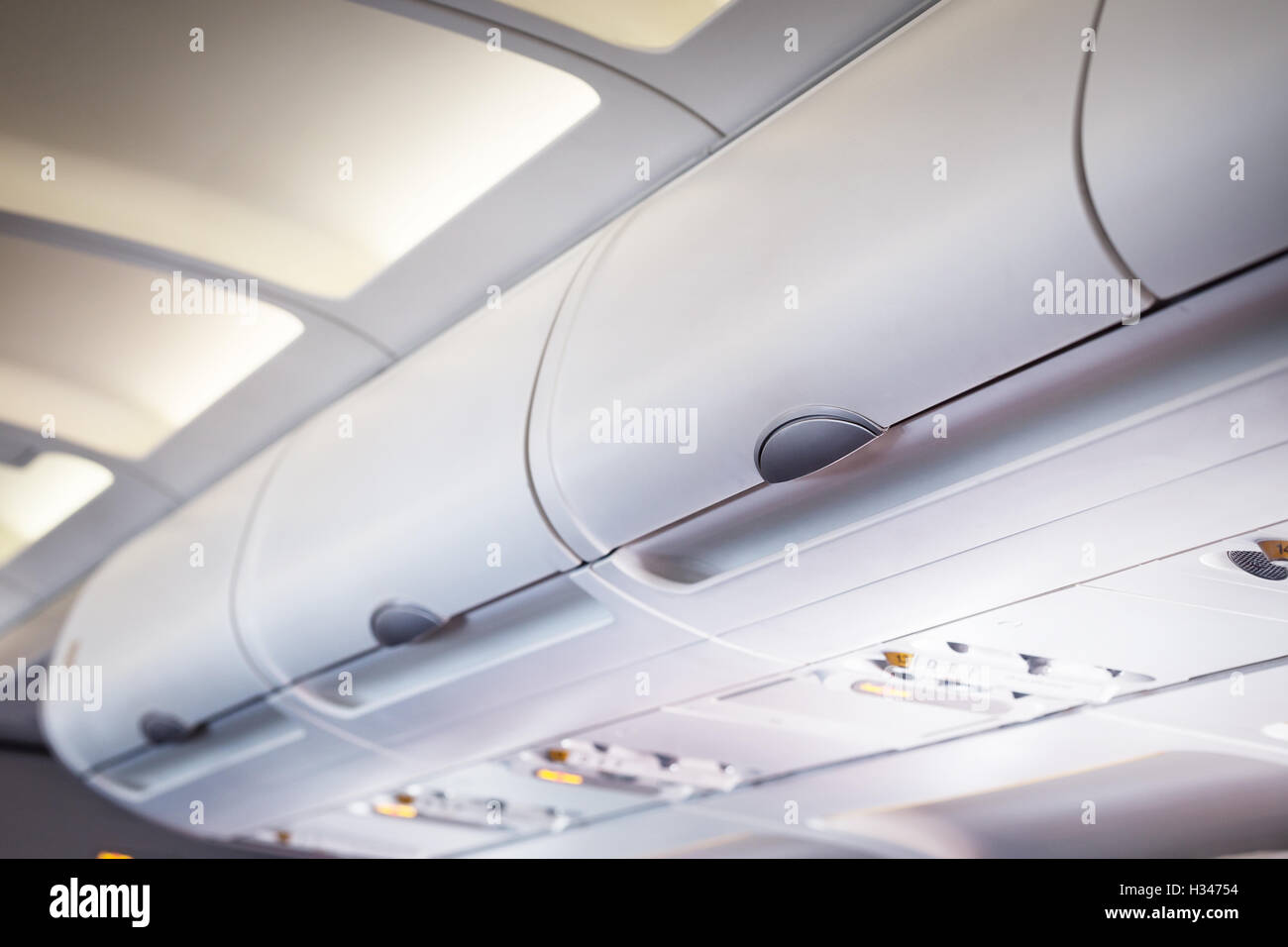 The luggage compartment in an airplane above passenger Stock Photo Alamy