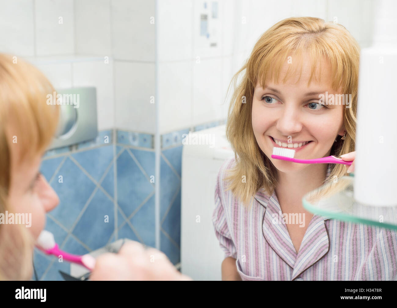 Woman brushing teeth in bathroom Stock Photo - Alamy