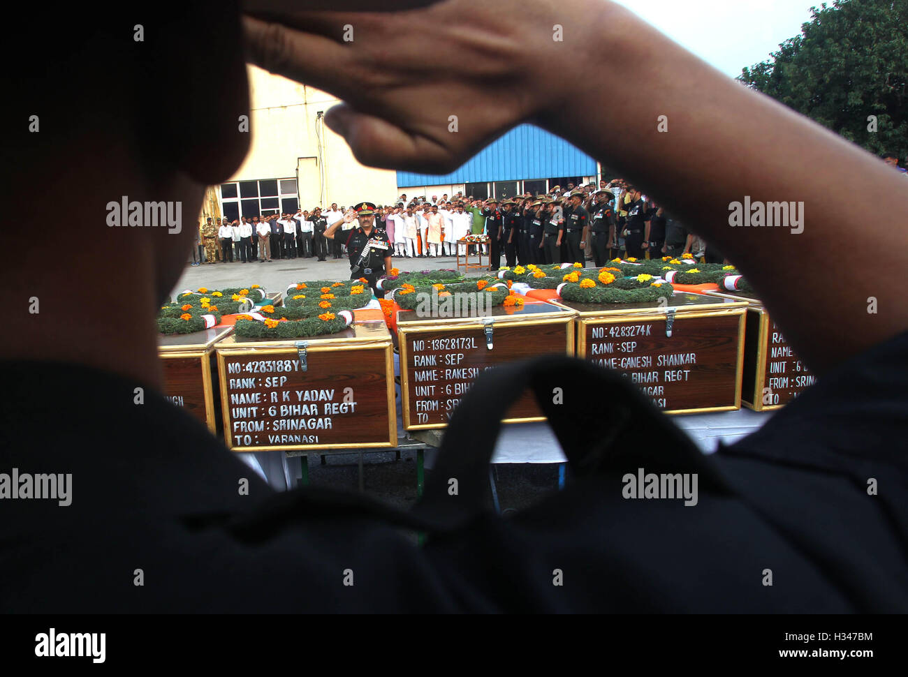 An Indian Army officer salutes the bodies of seven Indian Army soldiers who lost their lives in the Uri terror attack Varanasi Stock Photo