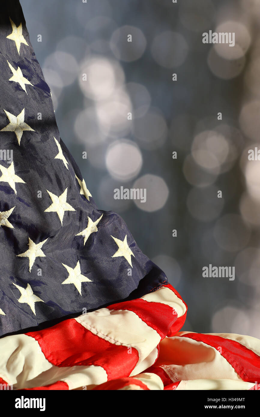Rippled american flag against blurred sparkling background with space for copy Stock Photo
