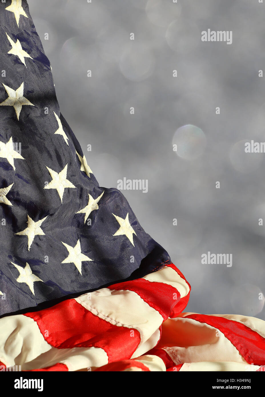 Rippled american flag against blurred sparkling background with space for copy Stock Photo