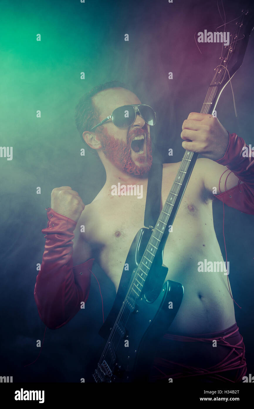 Metal, rocker man with electric guitar in a rock concert Stock Photo ...