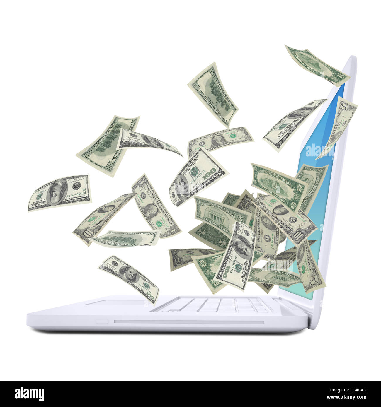 Dollar notes flying around the laptop Stock Photo - Alamy