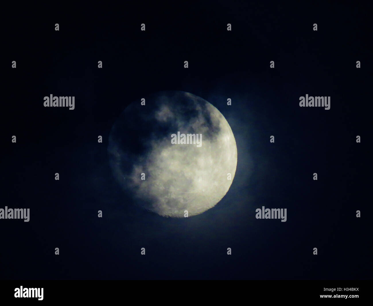 Full Moon with clouds rolling over it Stock Photo - Alamy