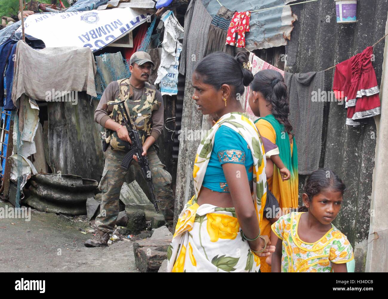 A Force One commando conducts a search and combing operation in a slum area of Uran, about 47 km East of Mumbai, Stock Photo