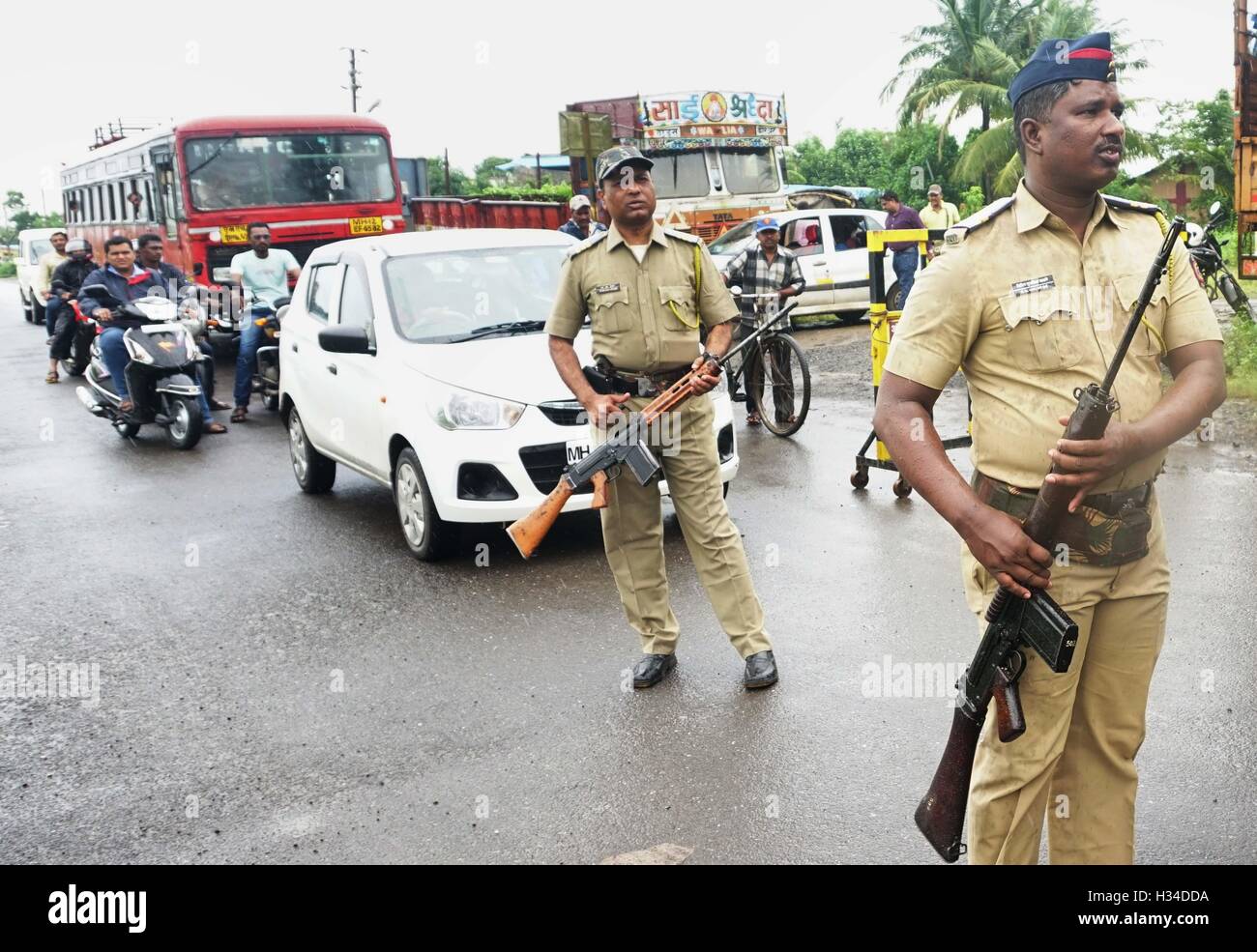 Armed policemen block the vehicular entry point into the city search and combing operations in Uran 47 km East of Mumbai Stock Photo