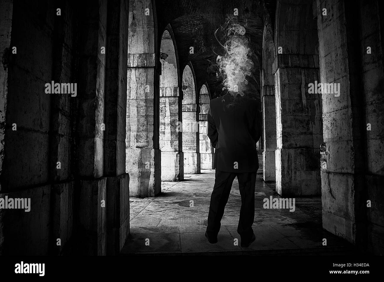 Nightmare, man with smoke head in old palace Stock Photo
