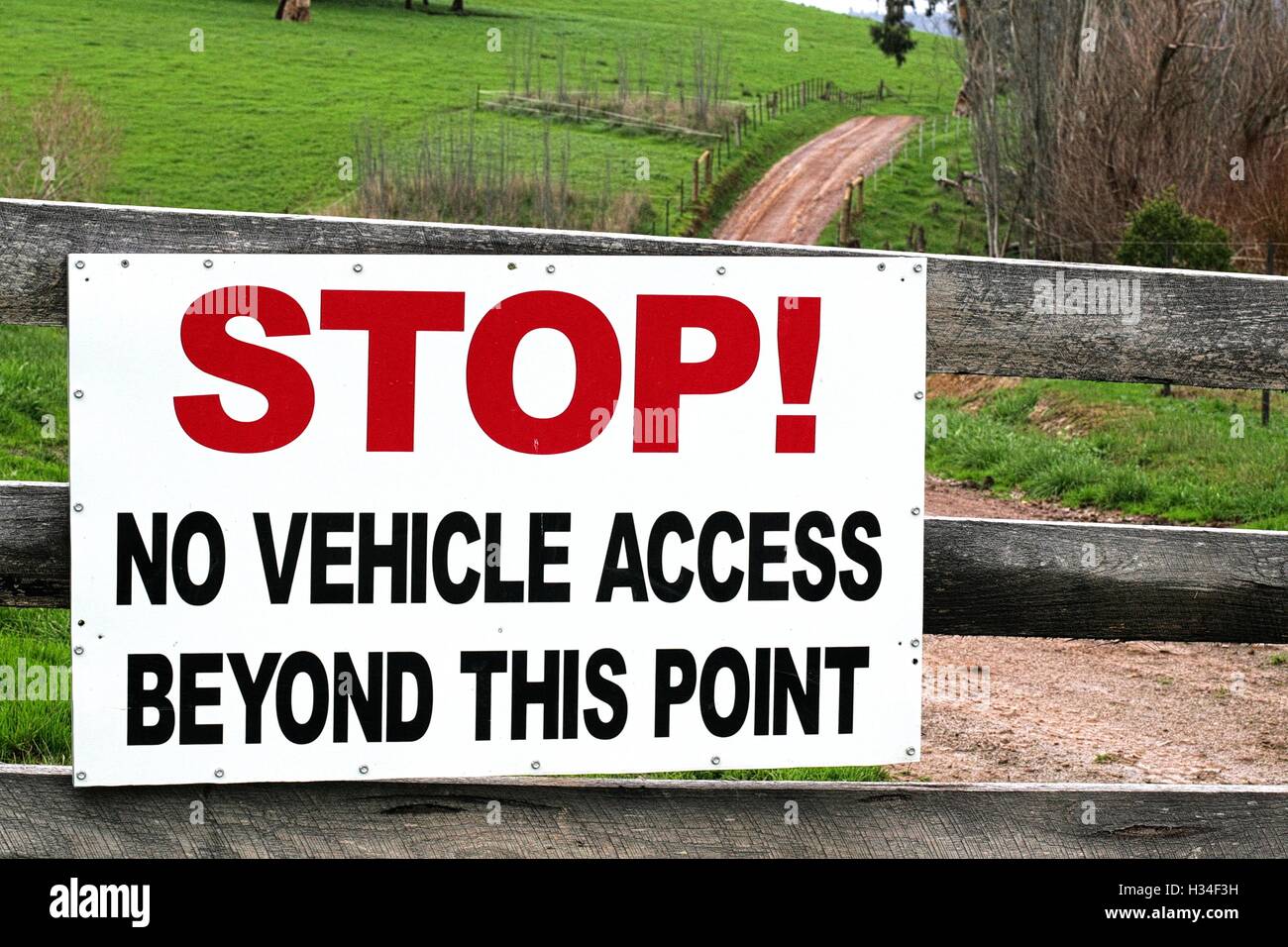 Large stop sign on a farm gate, stating no vehicle access beyond this point. Stock Photo