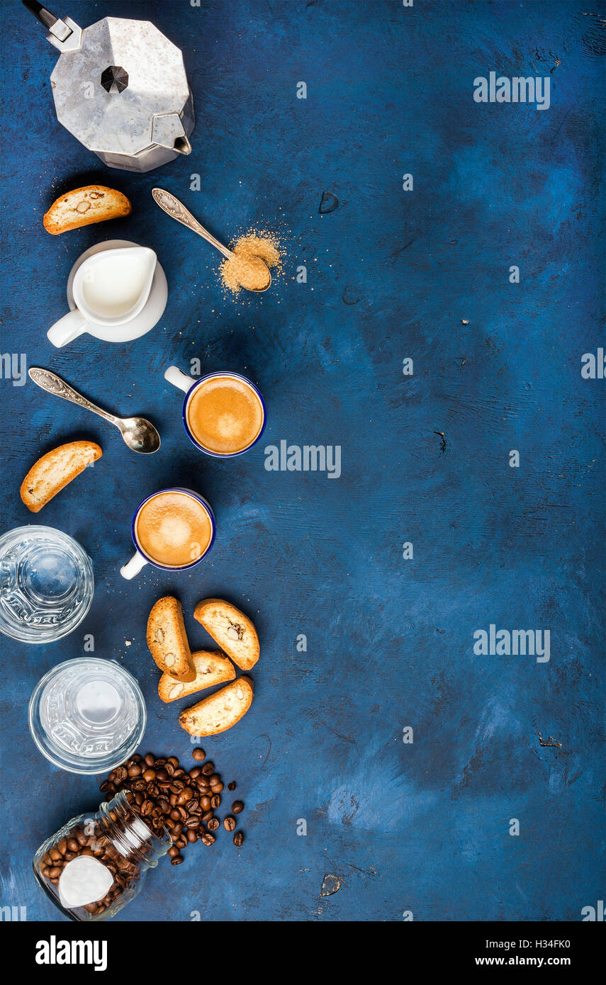 Coffee espresso, cantucci, cookies and milk over dark blue background Stock Photo