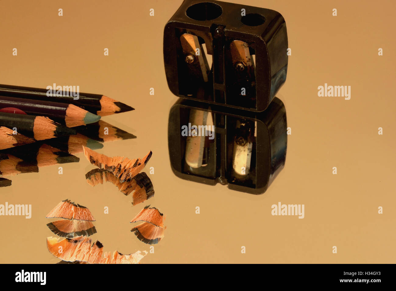 Eye pencils, sharpener and their reflection in the mirror Stock Photo