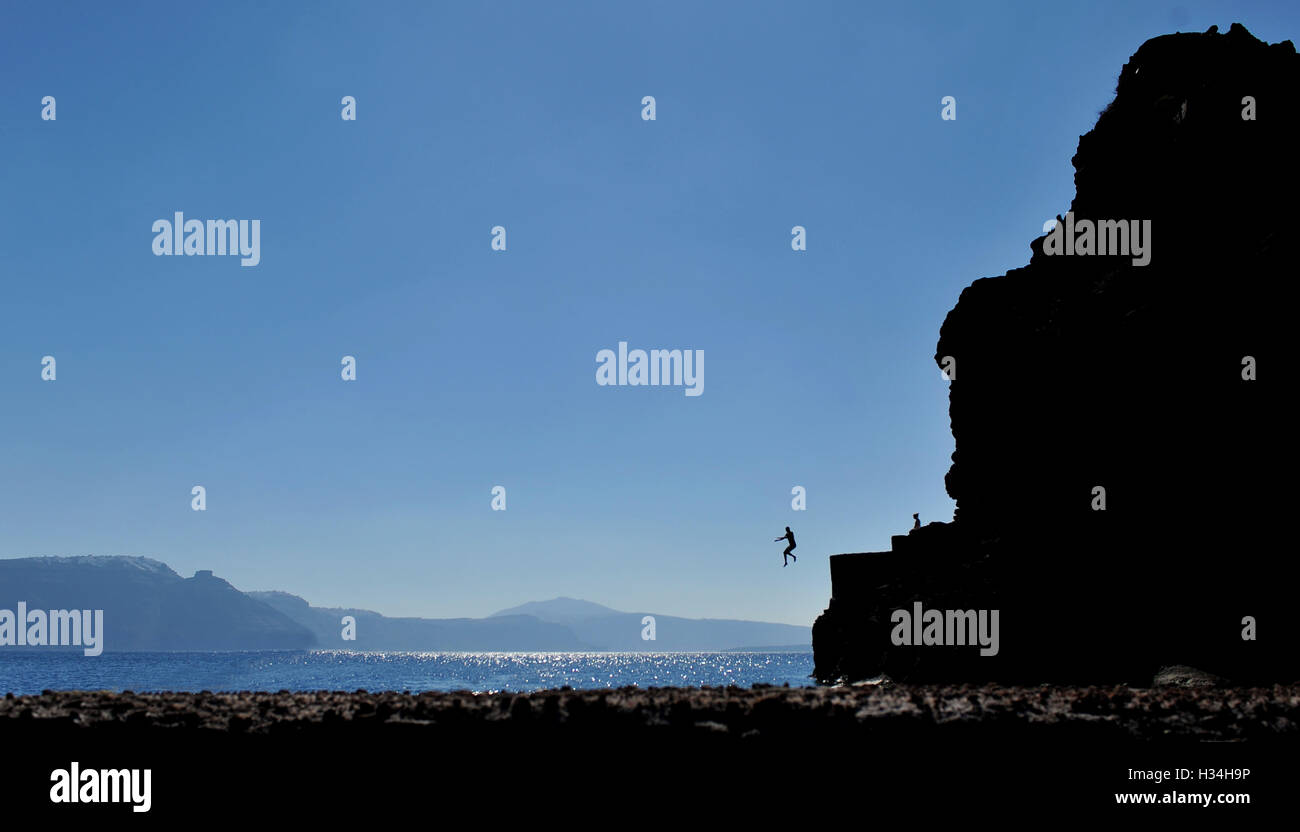 Santorini jump silhouette one sea Stock Photo
