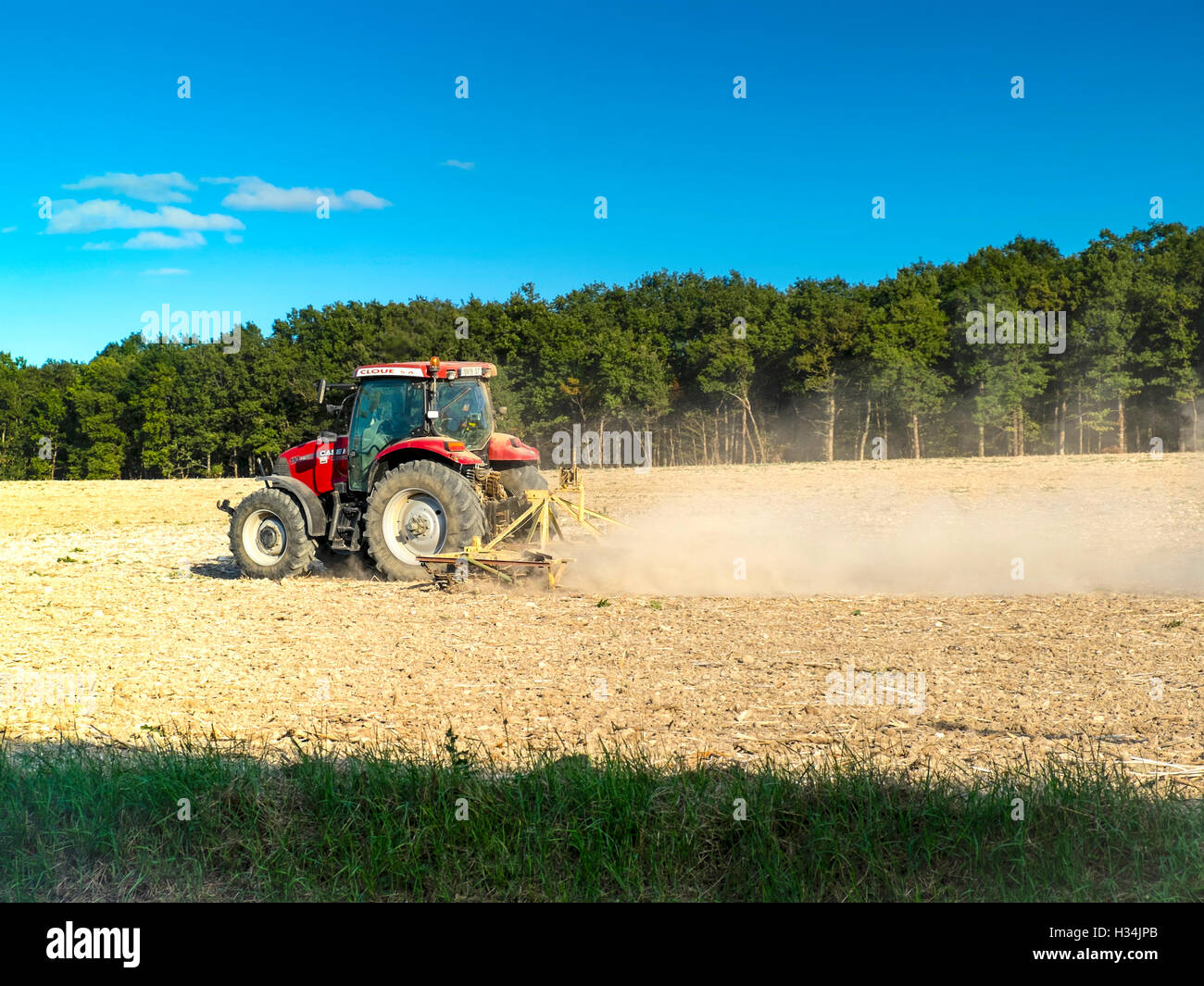 CASE 110 AX farm tractor tilling field - France. Stock Photo