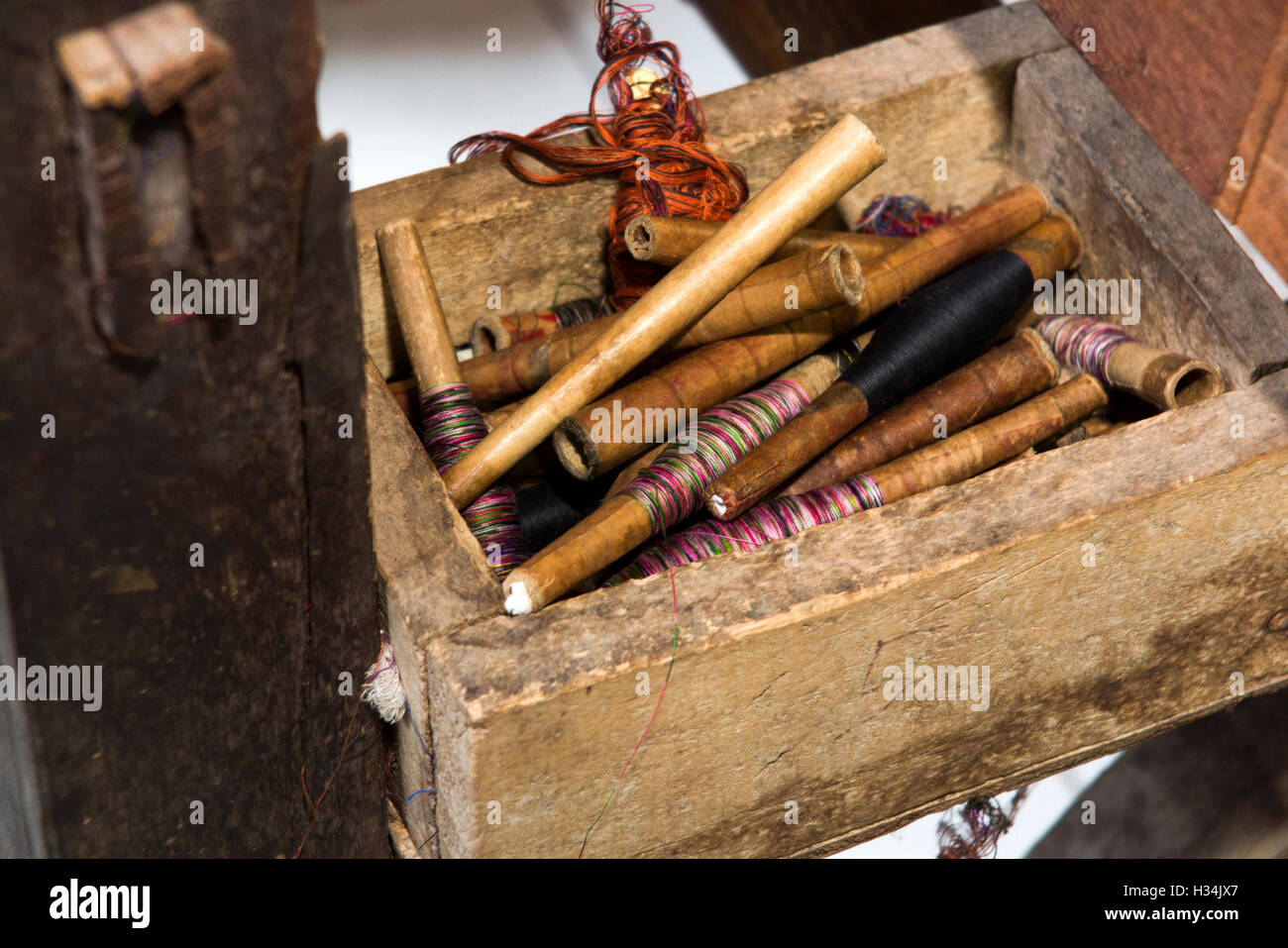 Indonesia, Bali, Singaraja, Pertenunan Berdikari weaving dyed threads on bobbins Stock