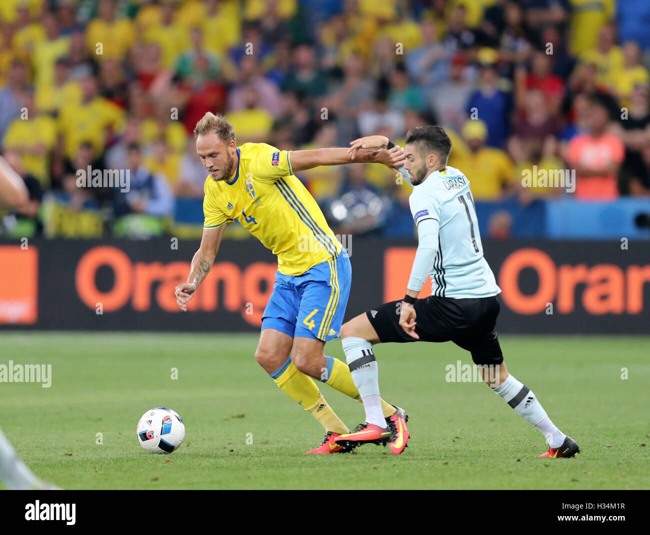 NICE, FRANCE - JUNE 22, 2016: Andreas Granqvist of Sweden (L) fights for a ball with Yannick Carrasco of Belgium during their UEFA EURO 2016 game at Allianz Riviera Stade de Nice, City of Nice, France Stock Photo
