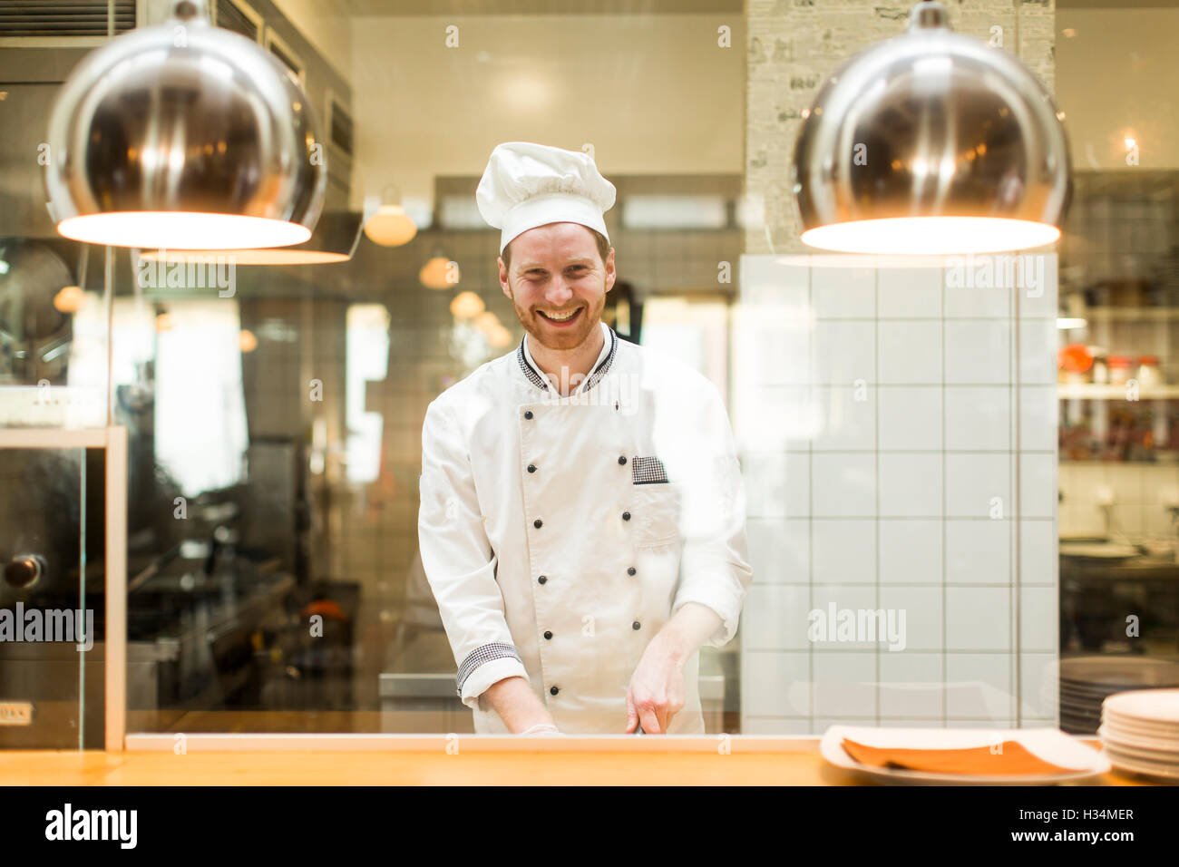 Chef preparing food in the kitchen at the restaurant Stock Photo