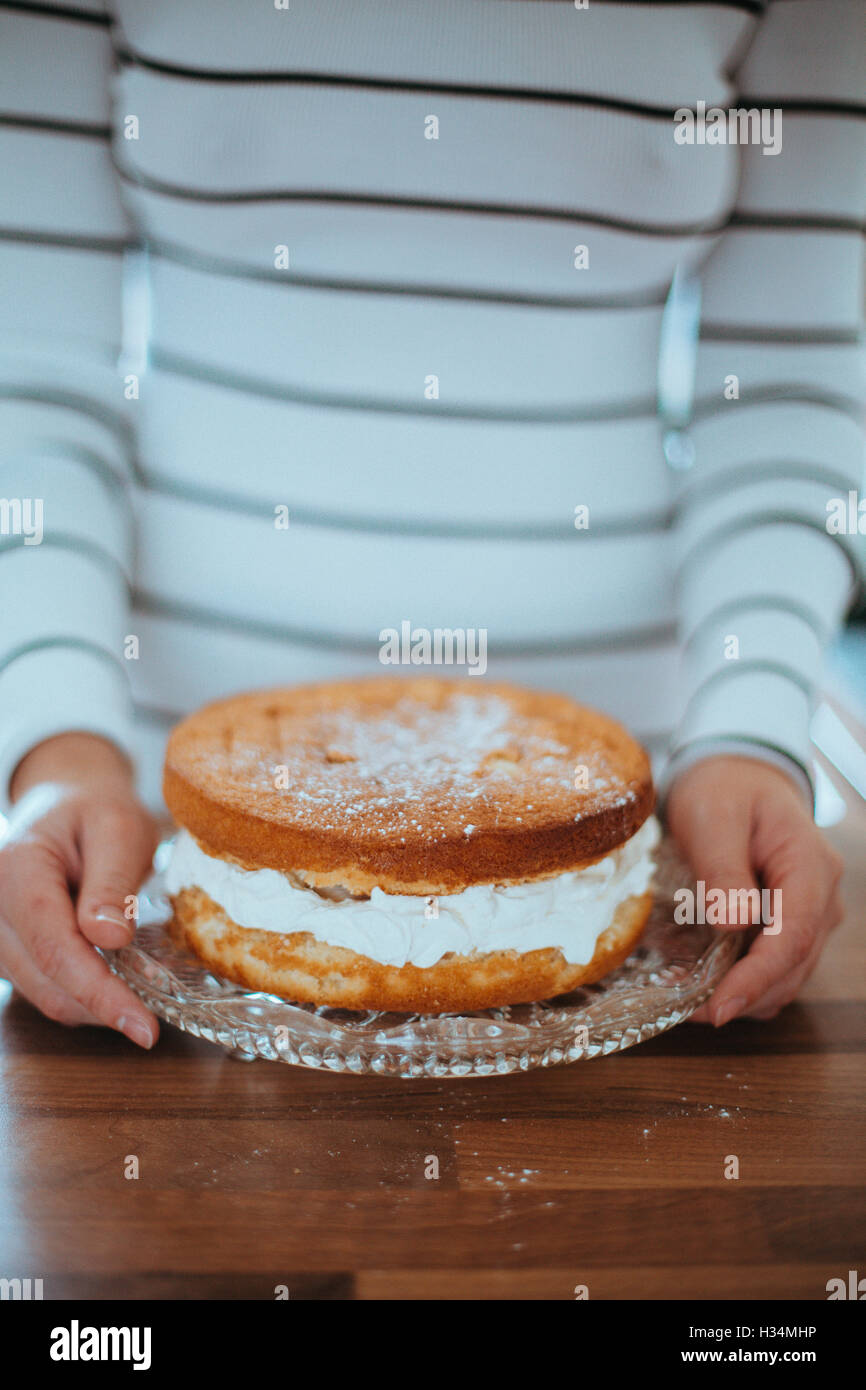 Woman with a beautiful baked cake. Stock Photo