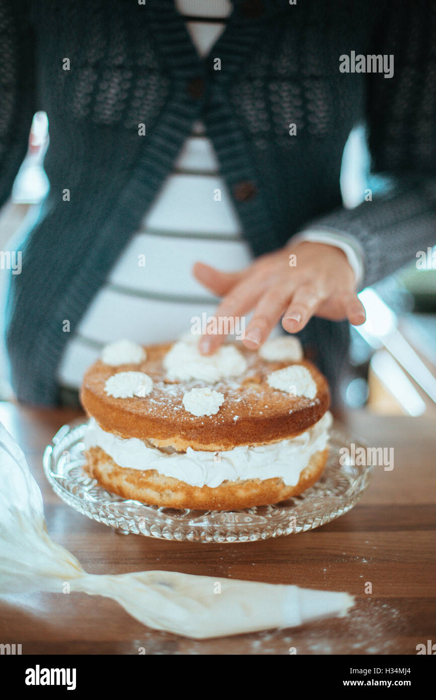 Woman with a beautiful baked cake. Stock Photo