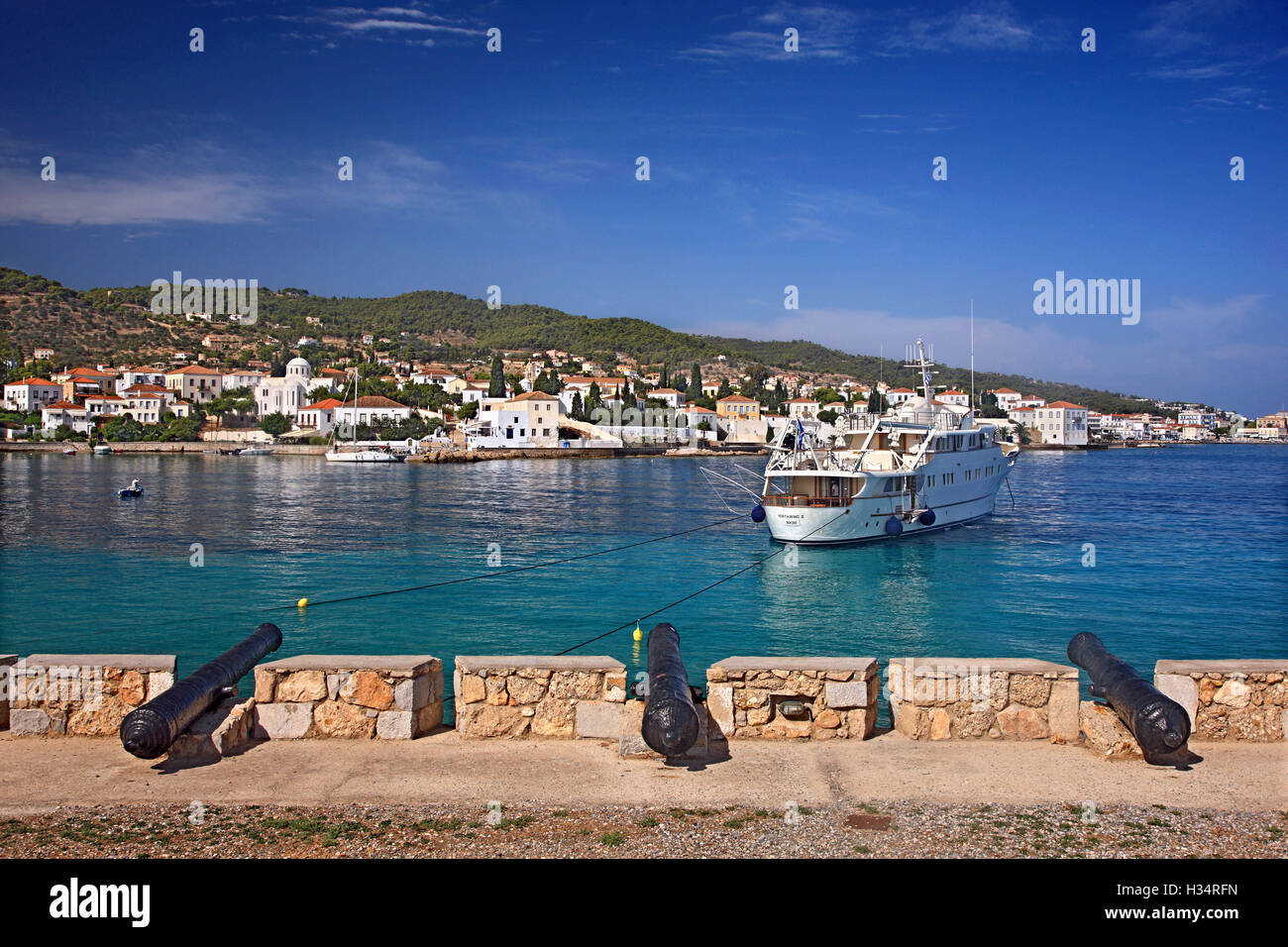 Old cannons (from the times of the Greek struggle for Independence) at the entrance of the old port of Spetses island, Attica, Stock Photo