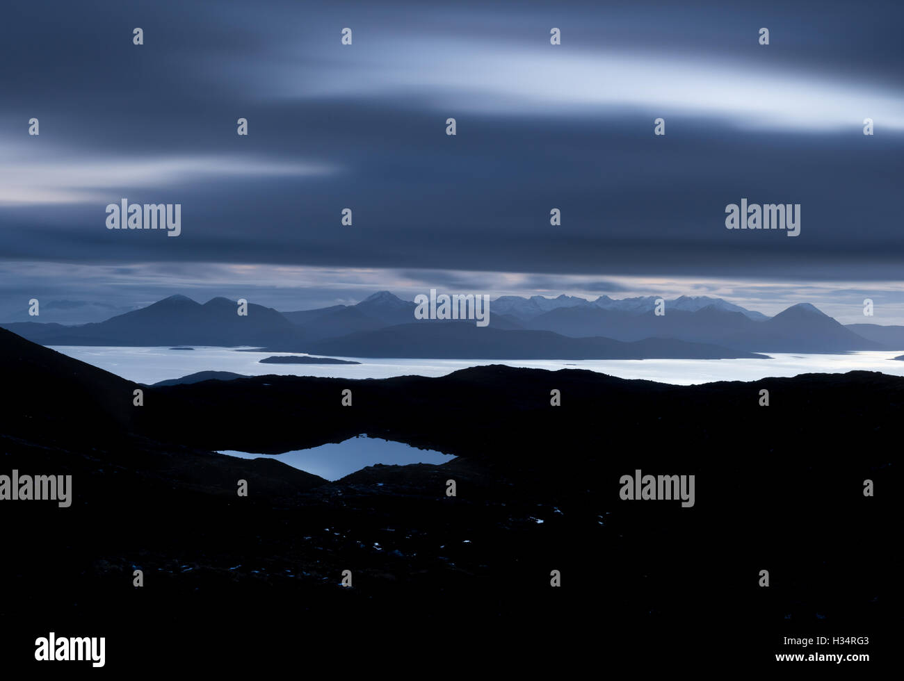 View from the Bealach na Ba towards the Isle of Skye after dark, Applecross Peninsula, Scottish Highlands Stock Photo