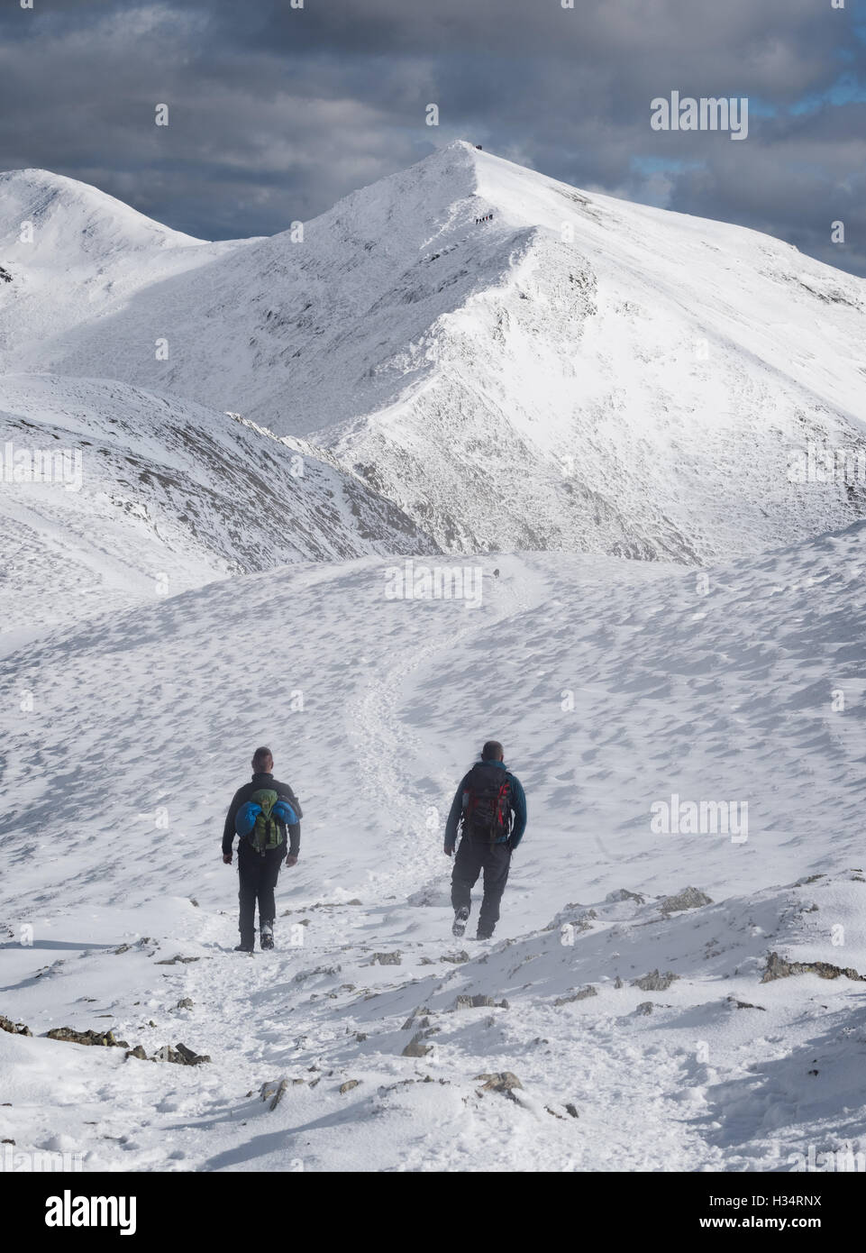 Walkers on the ridge Whiteside heading towards Hopegill Head in winter in the English Lake District national park, England, UK Stock Photo
