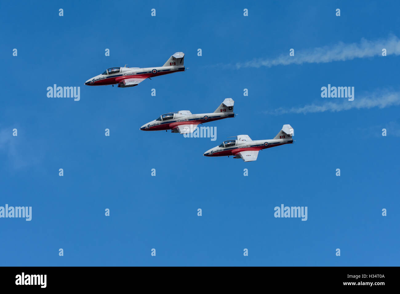 Canada SnowBirds 3 jets flying in formation smoke with trailing Stock Photo