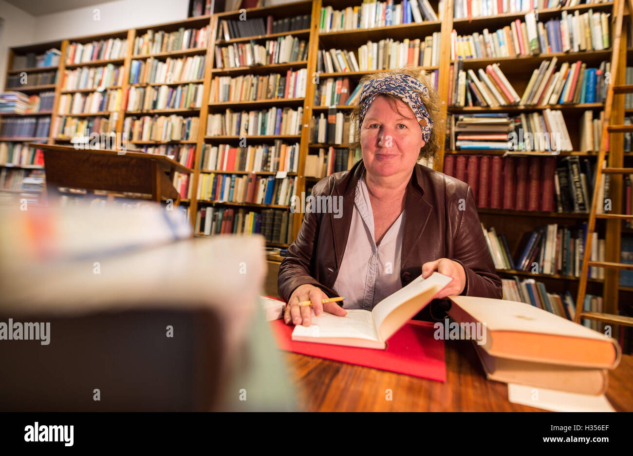 Book seller Angelika Schleindl sitting in her antiquarian bookshop Buchhandlung Schutt in the Bornheim district of Frankfurt am Main, Germany, 30 September 2016. PHOTO: FRANK RUMPENHORST/DPA Stock Photo