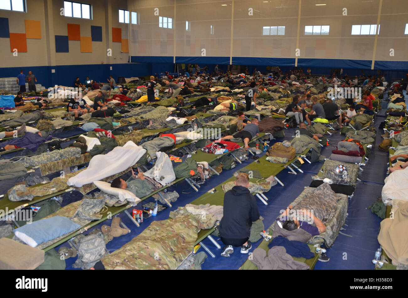 Guantanamo Bay, Cuba. 4th October, 2016. U.S. service members pack into the Denich Gym set up as an emergency shelter at Joint Task Force Guantanamo Bay in preparation for Hurricane Matthew October 4, 2016 in Guantanamo Bay, Cuba. Hurricane Matthew, a Category 4 storm with maximum sustained wind speeds of 145 mph and wind gusts of 170 mph slammed into the central Caribbean causing widespread damage. Credit:  Planetpix/Alamy Live News Stock Photo
