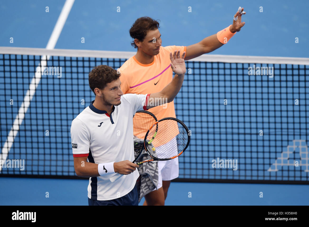 Beijing, China. 5th Oct, 2016. Rafael Nadal (R) and Pablo Carreno Busta of Spain wave to the audience after winning the men's doubles quarterfinal against Gong Maoxin and Zhang Ze of China at the China Open tennis tournament in Beijing, capital of China, Oct. 5, 2016. The Spanish pair won 2-0. Credit:  Ju Huanzong/Xinhua/Alamy Live News Stock Photo