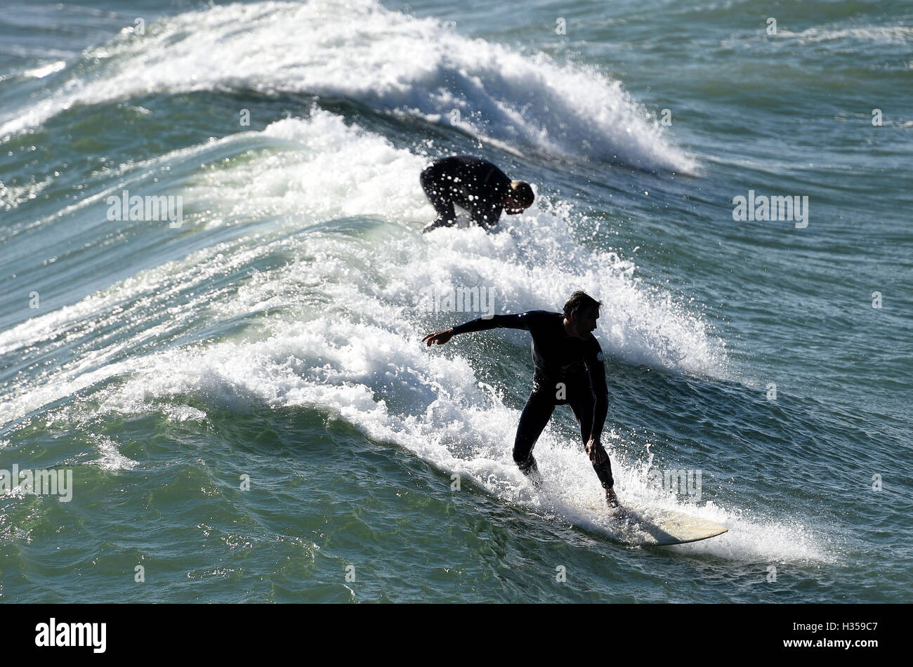 Surfers surfing at Bournemouth Beach, Dorset, UK Stock Photo Alamy