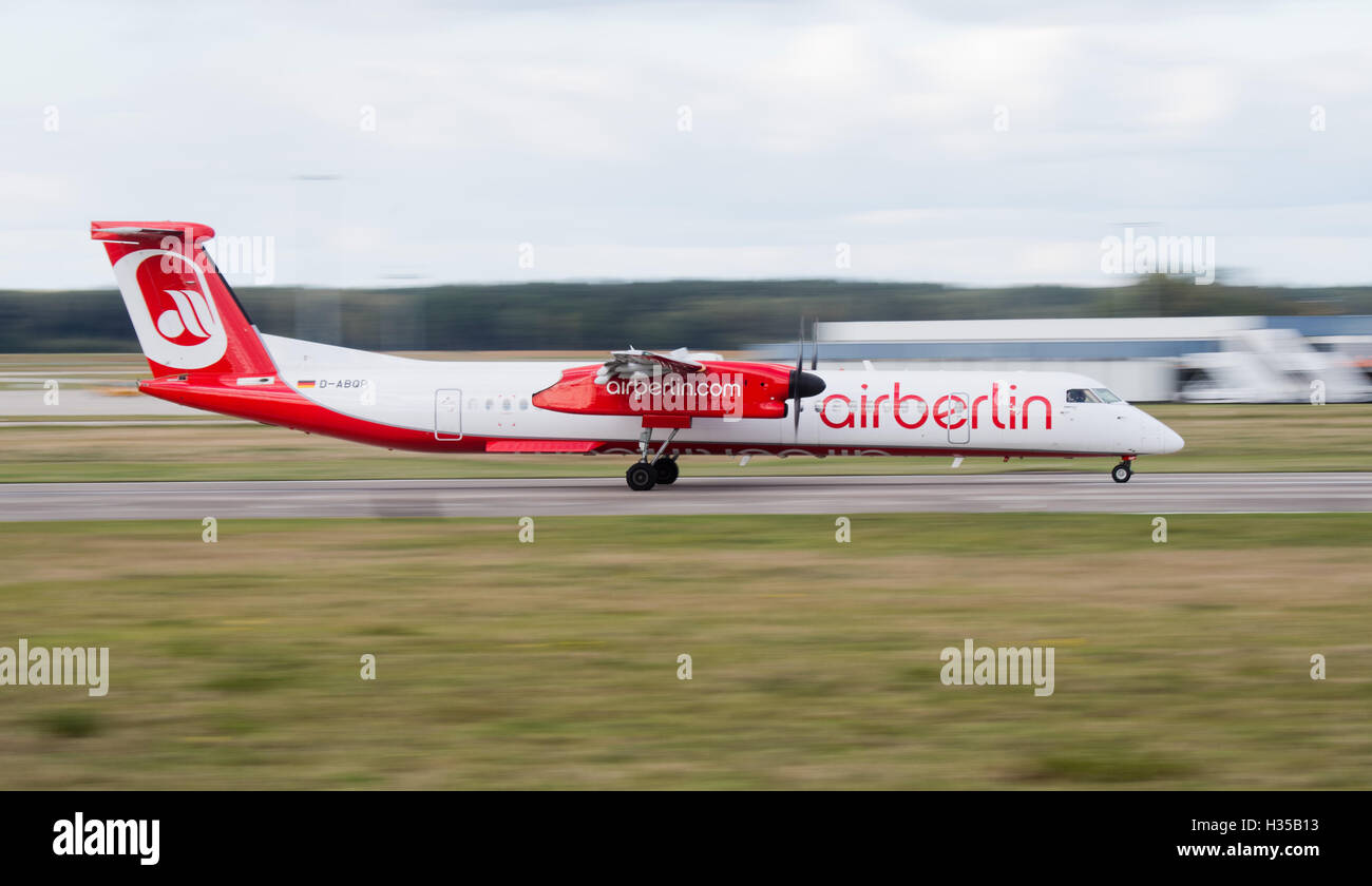 An Air Berlin Bombardier touches down on the runway of the airport in Hanover, Germany, 05 October 2016.  Airline company Etihad and tourism company Tui announced that they plan on merging parts of Air Berlin and Tuifly into a new venture offering holiday flights. Photo: JULIAN STRATENSCHULTE/dpa Stock Photo
