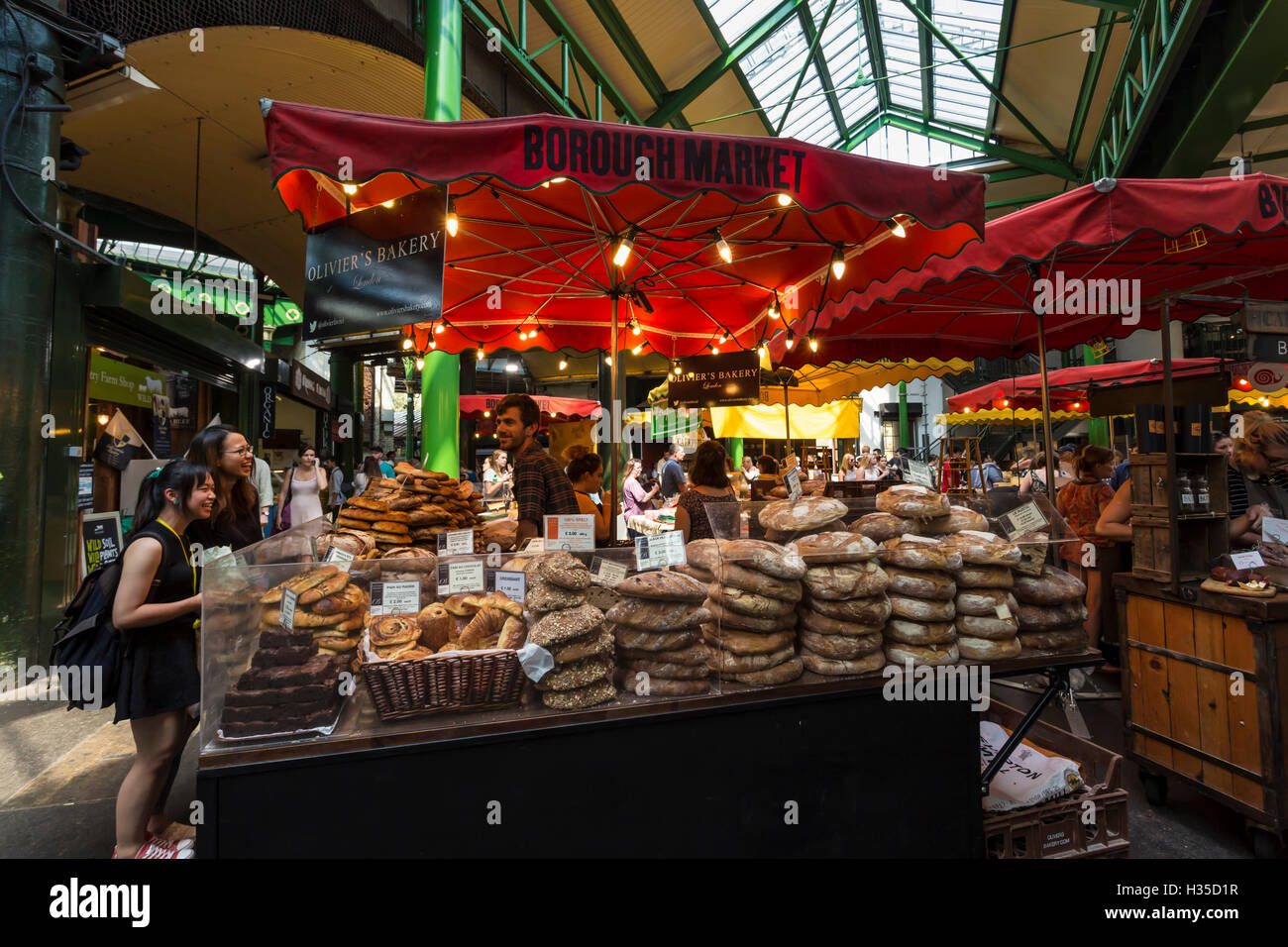 Customers at a bread stall, Borough Market, Britain's most renowned food market, Southwark, London, England, United Kingdom, Eur Stock Photo