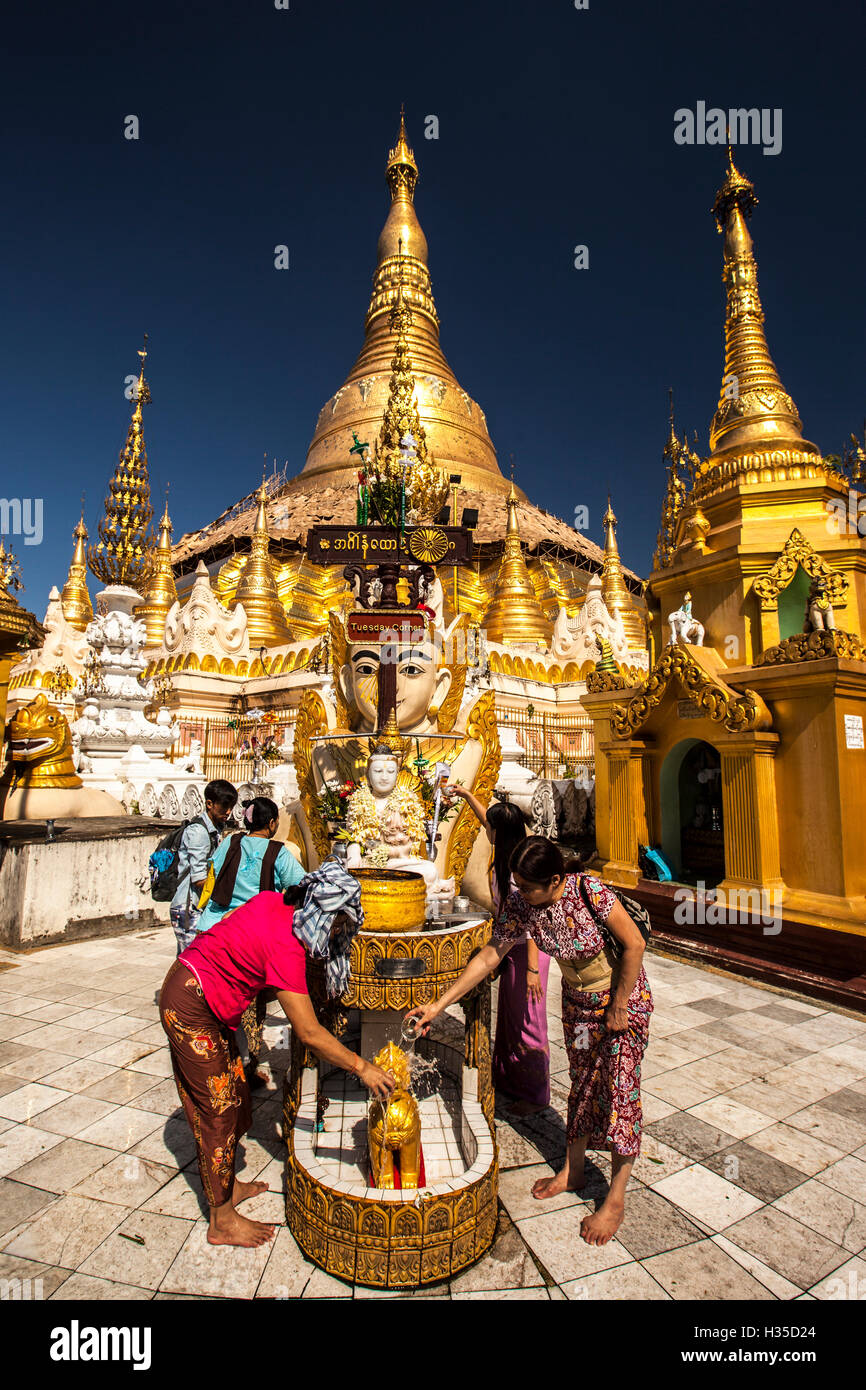 Water offering at Tuesday Corner statue, Shwedagon Paya, Yangon (Rangoon), Myanmar (Burma), Asia Stock Photo