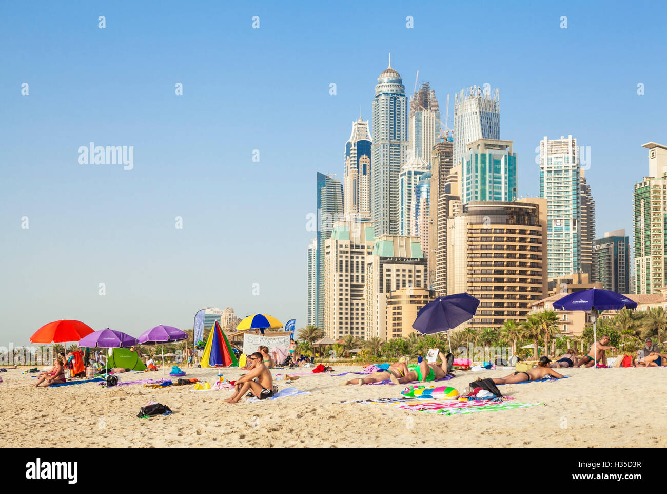 Sunbathers on the Public Dubai Beach at JBR (Jumeirah Beach Resort), Dubai, United Arab Emirates, Middle East Stock Photo