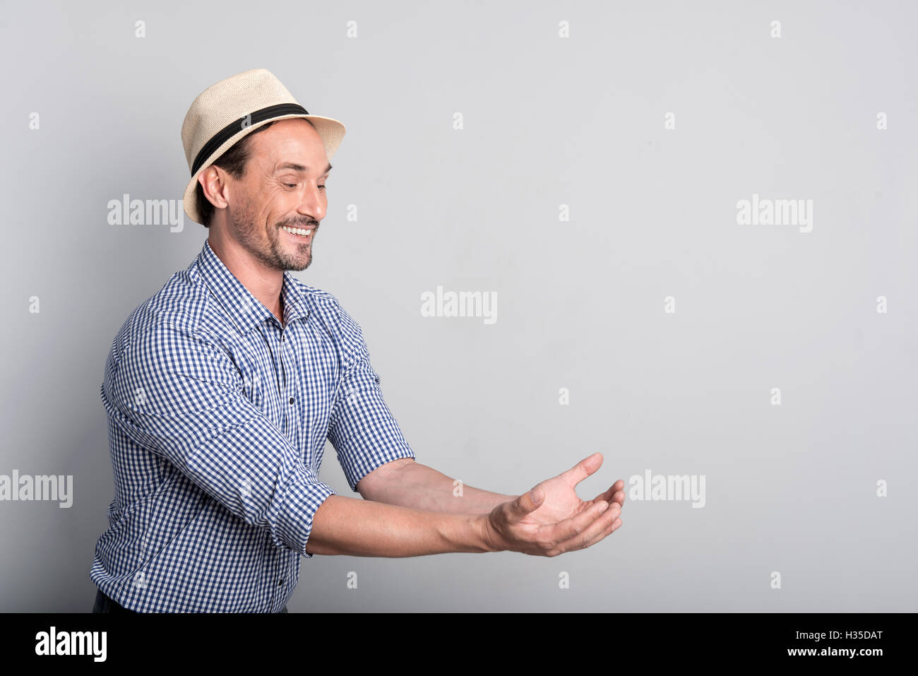 Happy middle aged man holding his arms together Stock Photo - Alamy