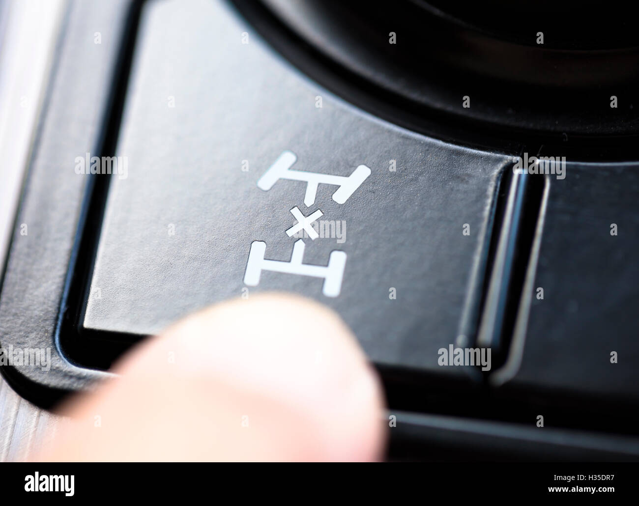 finger pressing the 4wd button in car Stock Photo