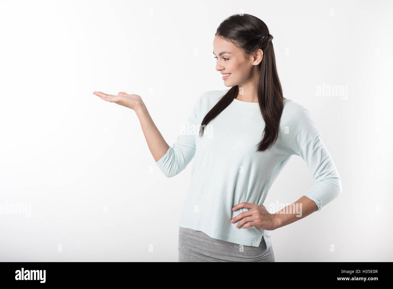 Positive woman pointing aside. Stock Photo