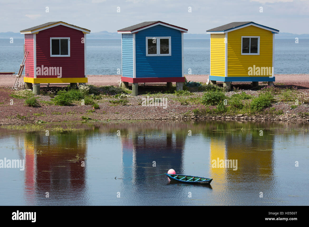 Colourfully painted huts by the shore of the Atlantic Ocean at Heart's Delight-Islington in Newfoundland and Labrador, Canada Stock Photo