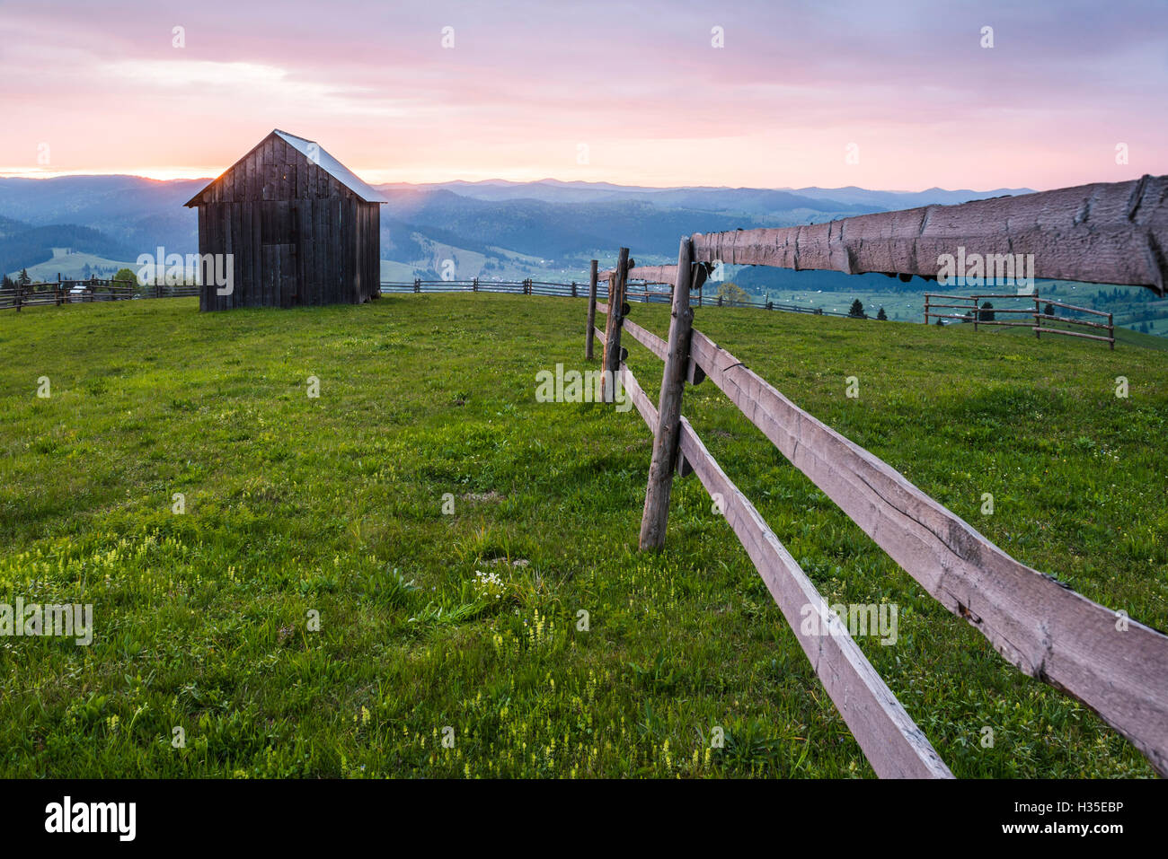 Rural Romanian landscape at sunrise in the Bukovina Region (Bucovina), Paltinu, Romania Stock Photo