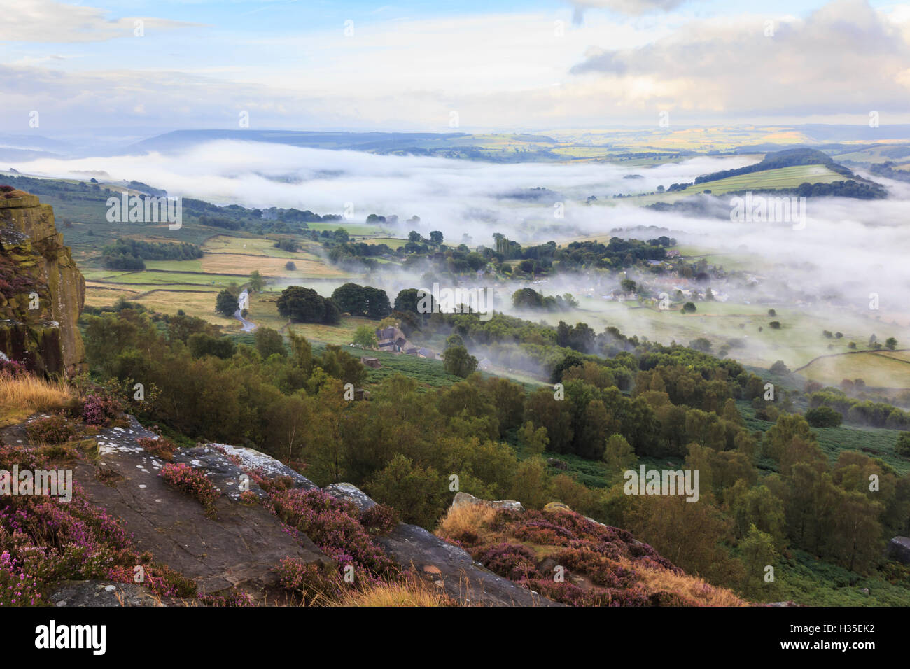 Early morning fog around Curbar village, from Curbar Edge, Peak District National Park, late summer heather, Derbyshire, UK Stock Photo