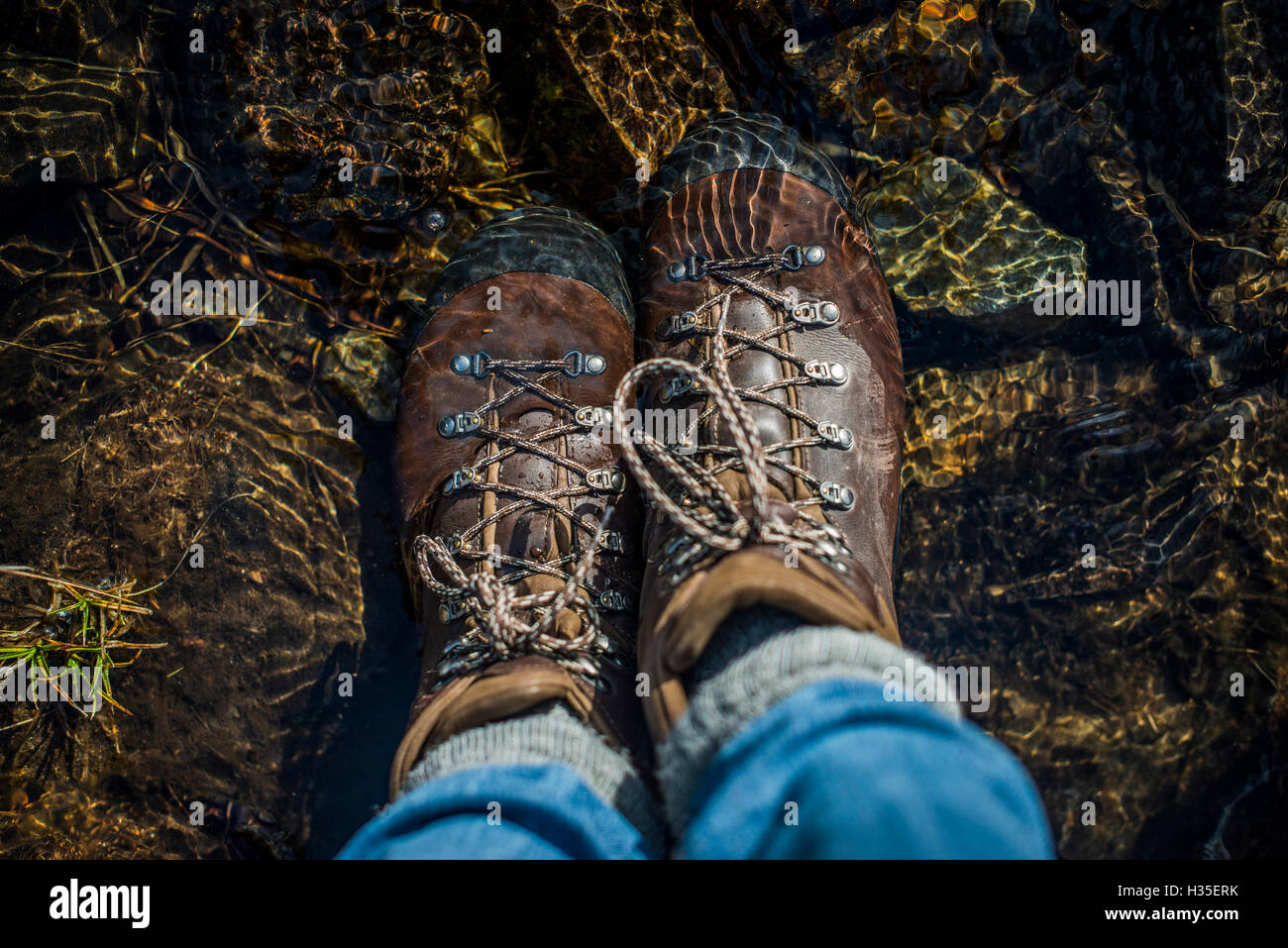 Boots in a stream, Cumbria, England, UK Stock Photo Alamy