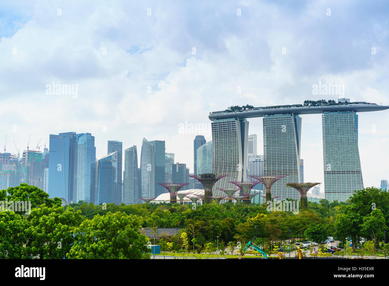 View over the Gardens by the Bay to the three towers of the Marina Bay Sands Hotel and city skyline beyond, Singapore Stock Photo