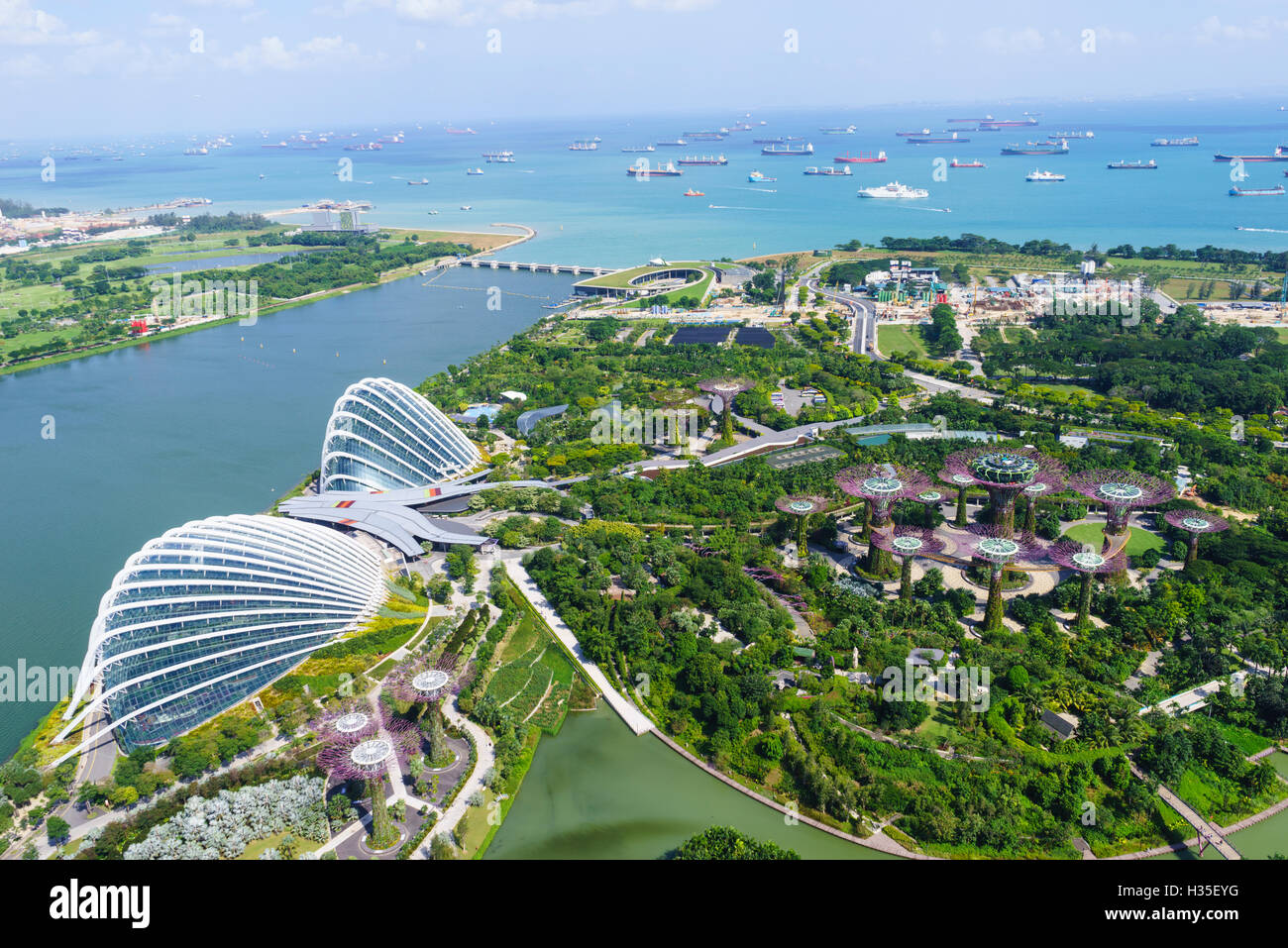 High view overlooking the Gardens by the Bay botanical gardens with its conservatories and Supertree Grove, Singapore Stock Photo