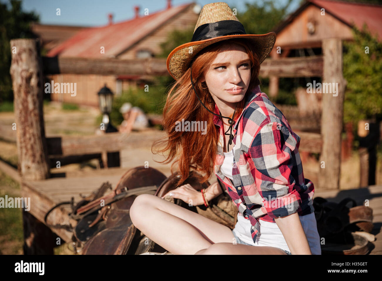 Closeup of beautiful redhead young woman cowgirl in hat Stock Photo