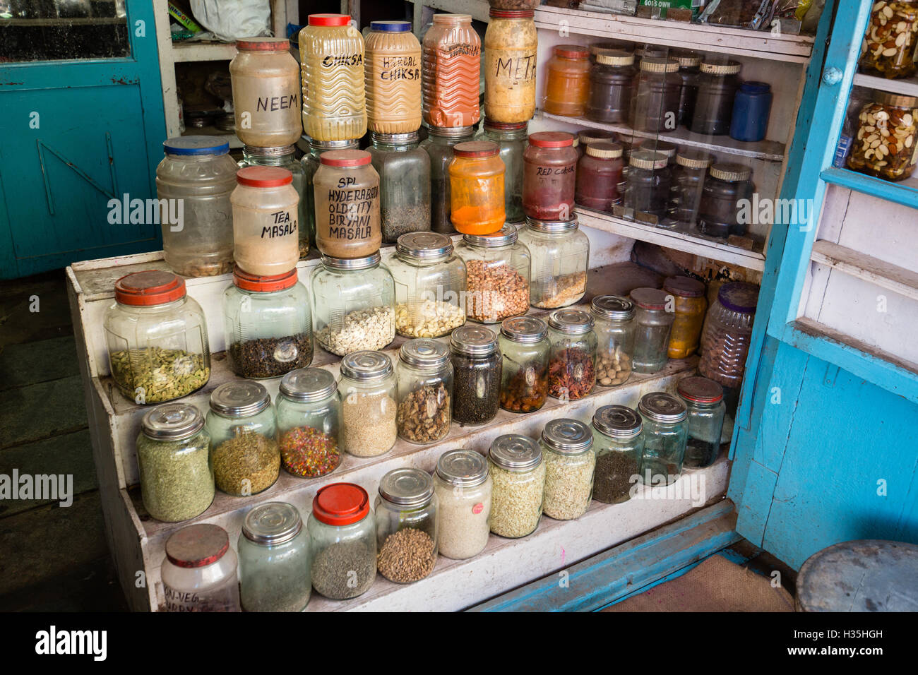 Indian spices and condiments in plastic and glass bottle jars in