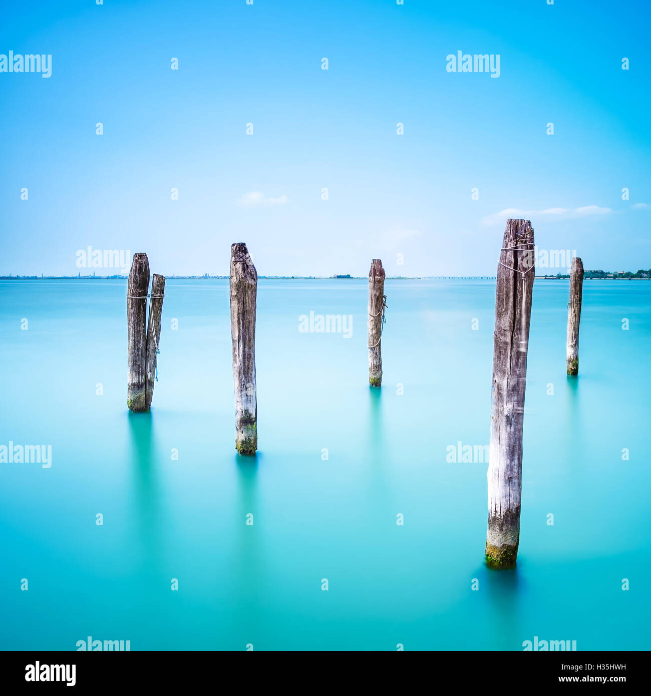 Poles and soft water on Venice lagoon. Long exposure photography. Stock Photo