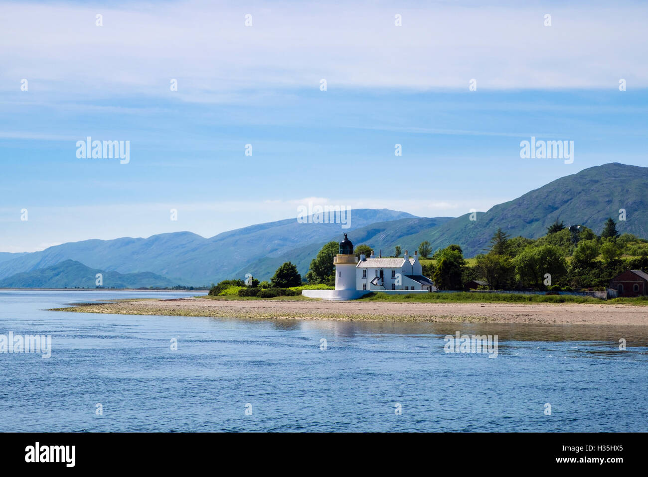 Offshore view to Corran lighthouse and lodge on shore of Loch Linnhe. Ardgour Fort William Inverness-shire Highland Scotland UK Stock Photo