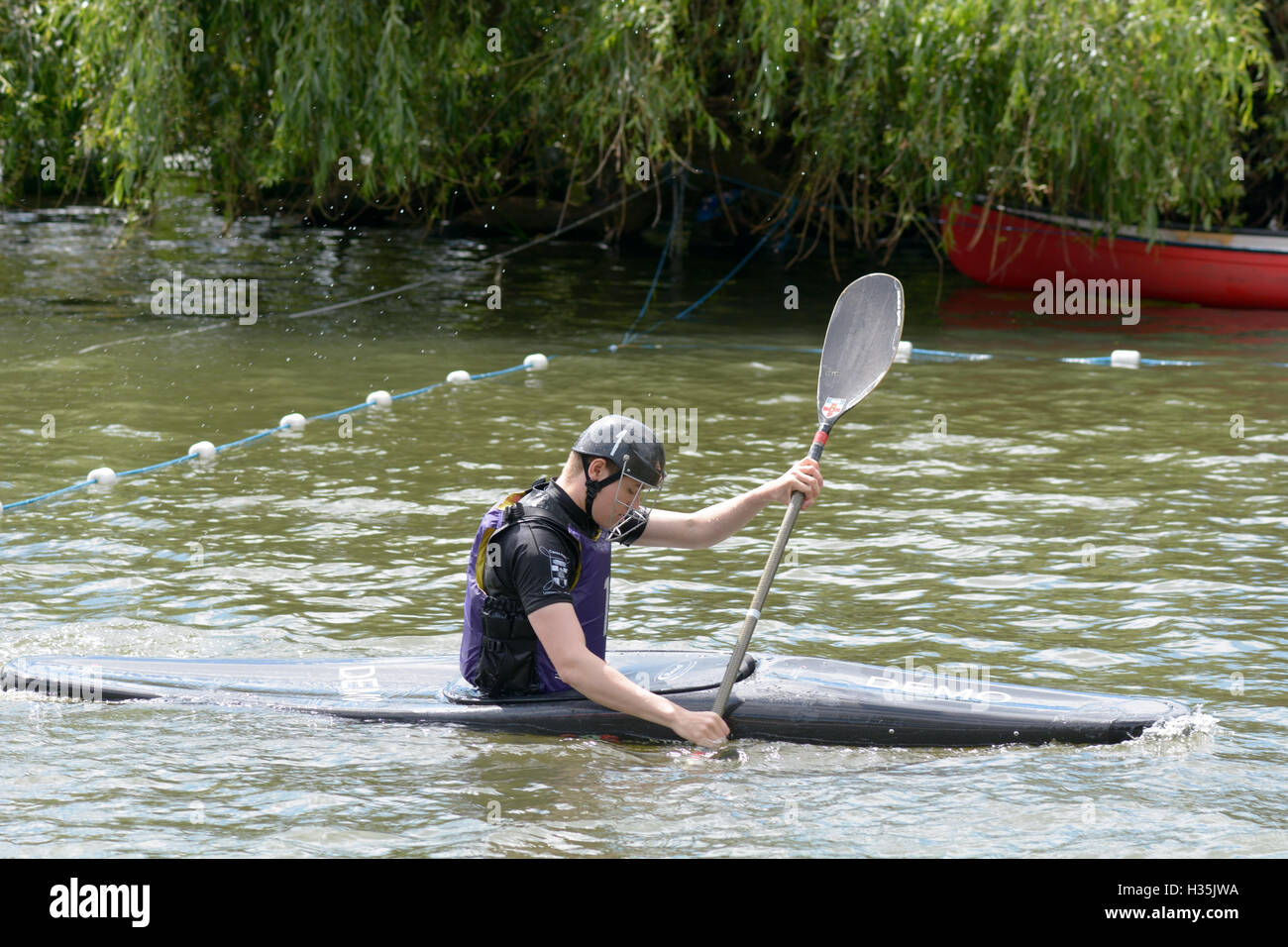 Participants in a canoe water polo match competing to win on the River