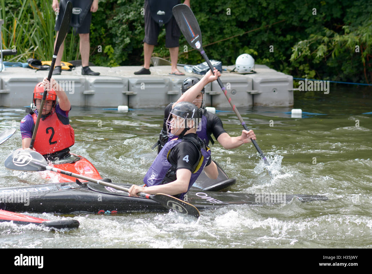 Participants in a canoe water polo match competing to win on the River