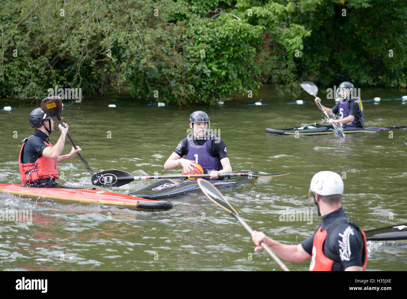 Participants in a canoe water polo match competing to win on the River