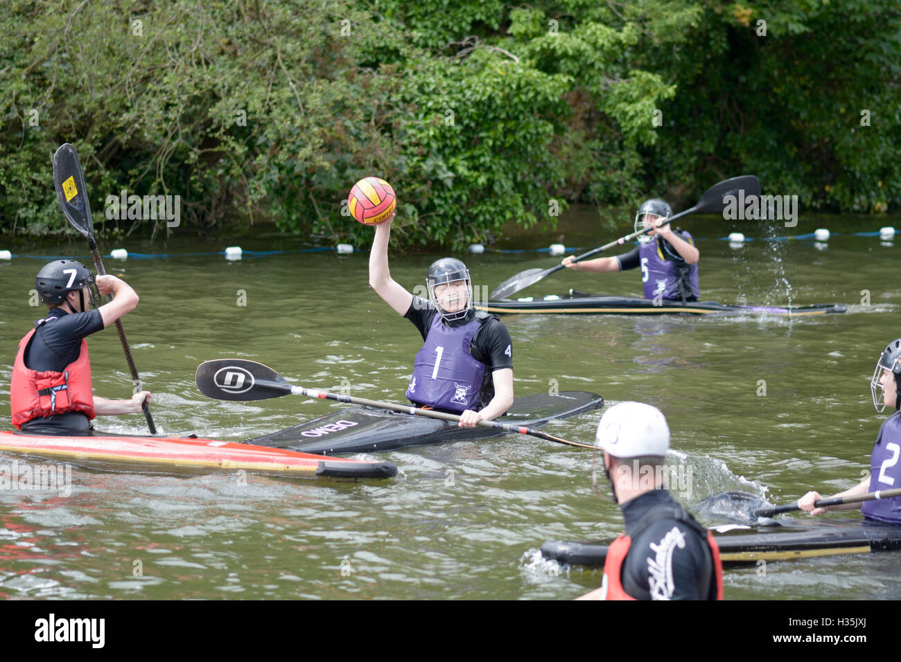 Participants in a canoe water polo match competing to win on the River